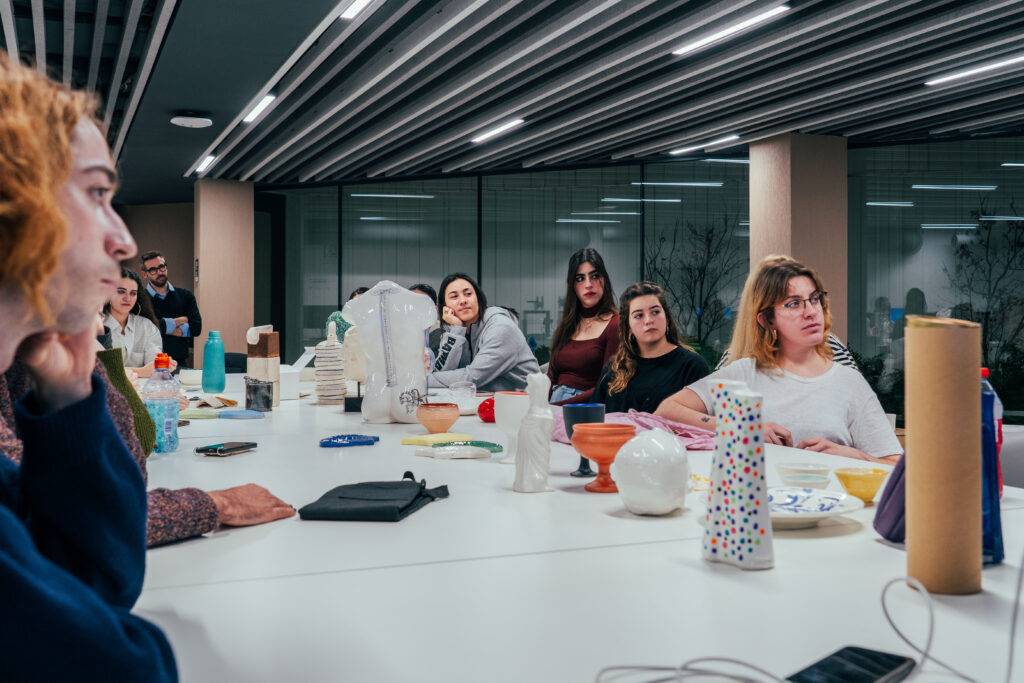 Un grupo de personas presta atención durante una actividad en un espacio de trabajo compartido.