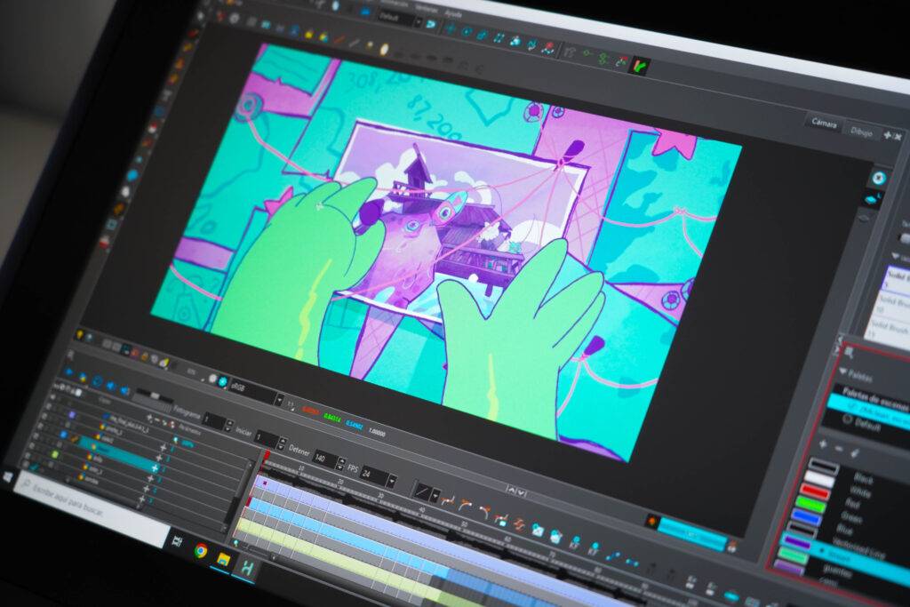 La imagen muestra una pantalla de ordenador con un software de animación abierto y unos guantes verdes interactuando con la interfaz.