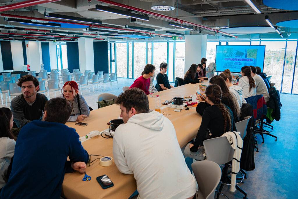 Un grupo de personas se reúne en una sala moderna para colaborar en un proyecto.