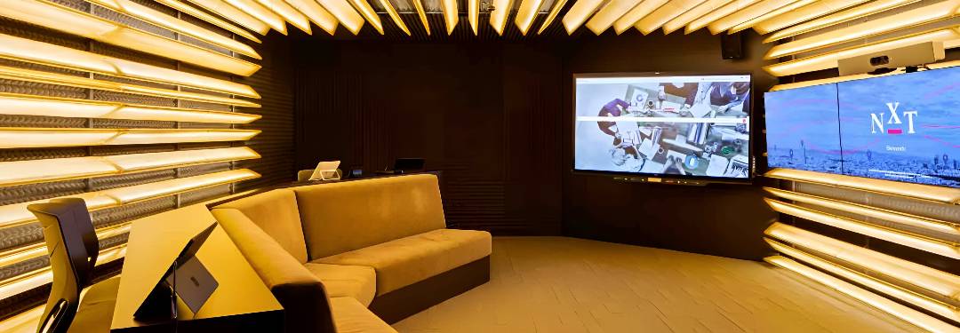 Una sala moderna con iluminación LED y pantallas digitales.