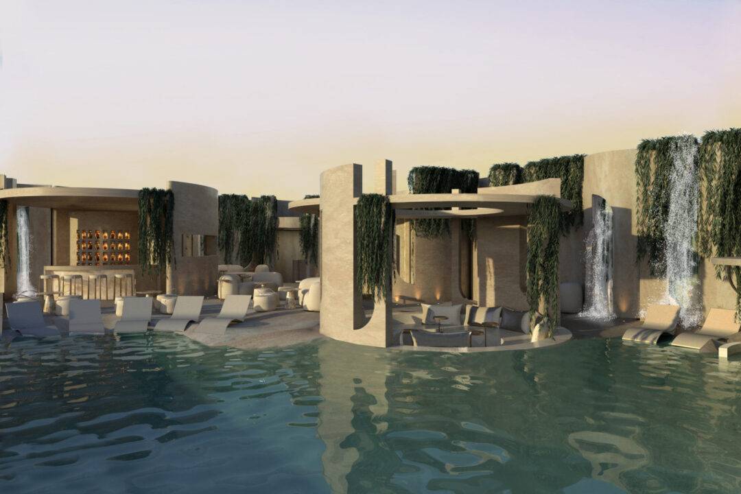 Una moderna construcción junto a una piscina con cascadas y vegetación.