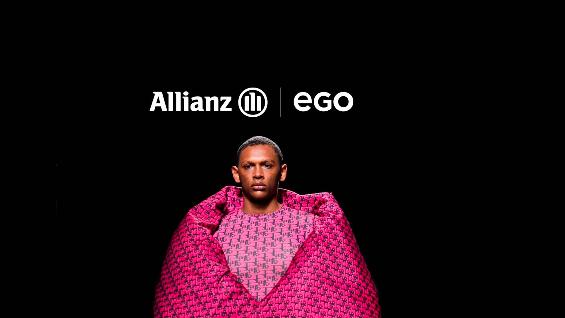 Un hombre envuelto en una manta rosa frente a un fondo negro con el logotipo de Allianz y EGO.