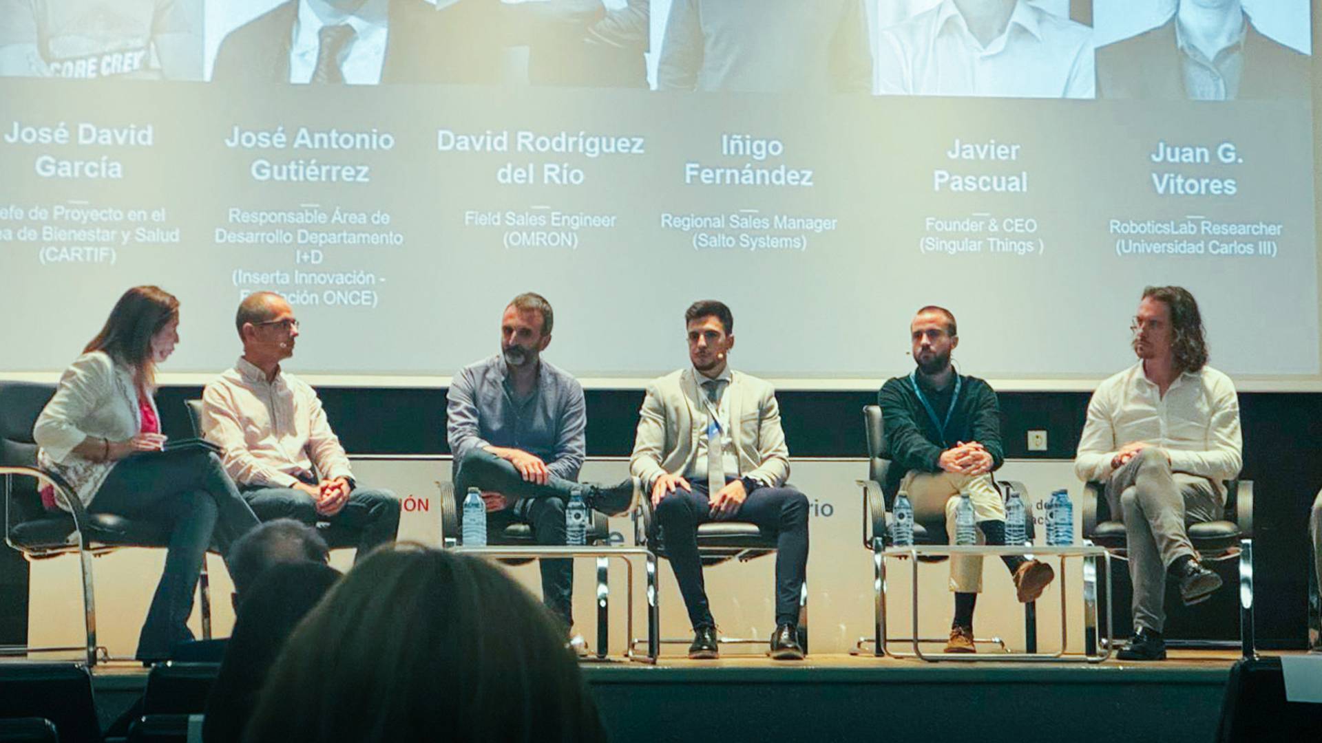 Panel de discusión con varios expertos en un evento de tecnología.