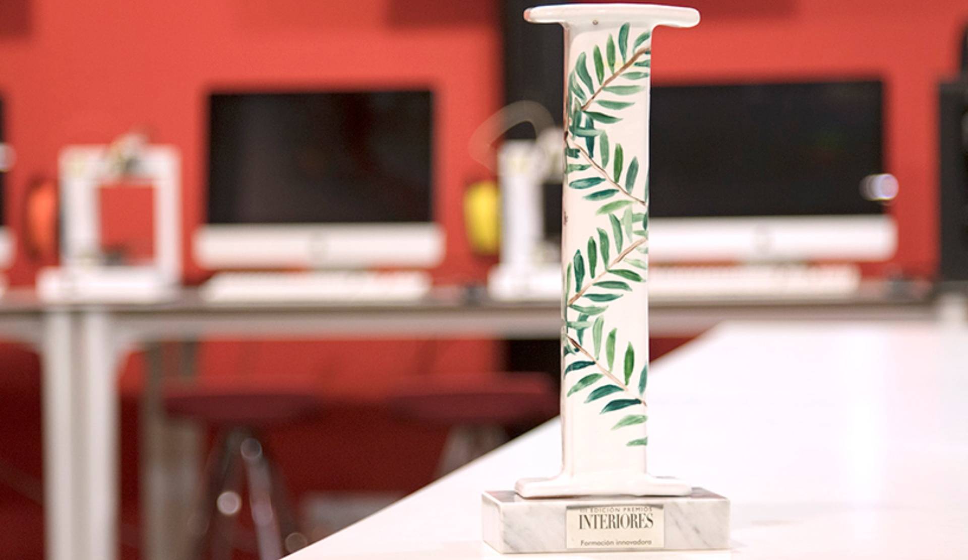 Un trofeo decorado con hojas verdes sobre una base de mármol.