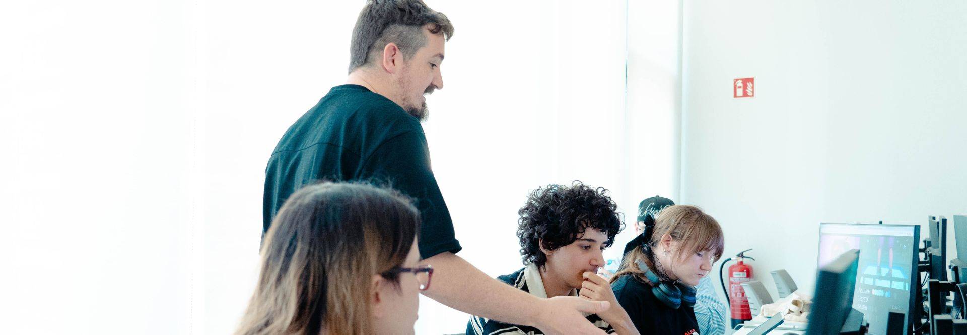 Un grupo de personas trabajando en computadoras en un ambiente colaborativo.