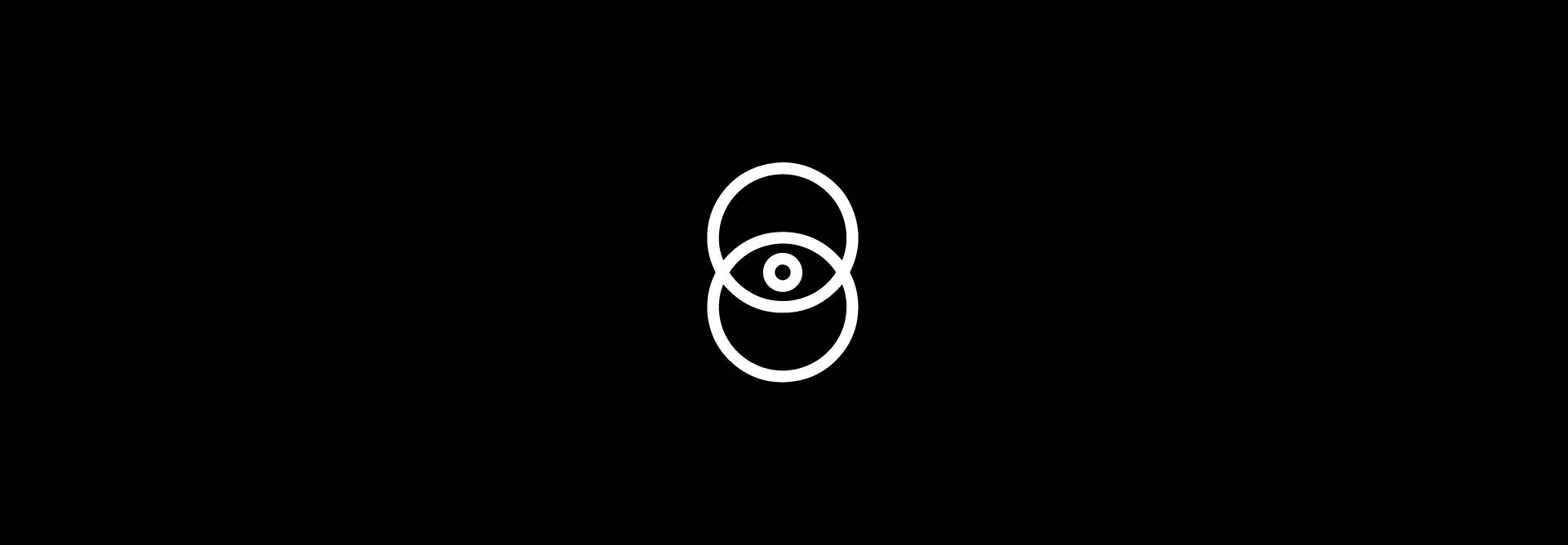 Un diseño minimalista que muestra un ojo dentro de dos círculos entrelazados sobre un fondo negro.