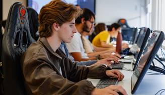 Un grupo de jóvenes trabajando en computadoras en un aula.