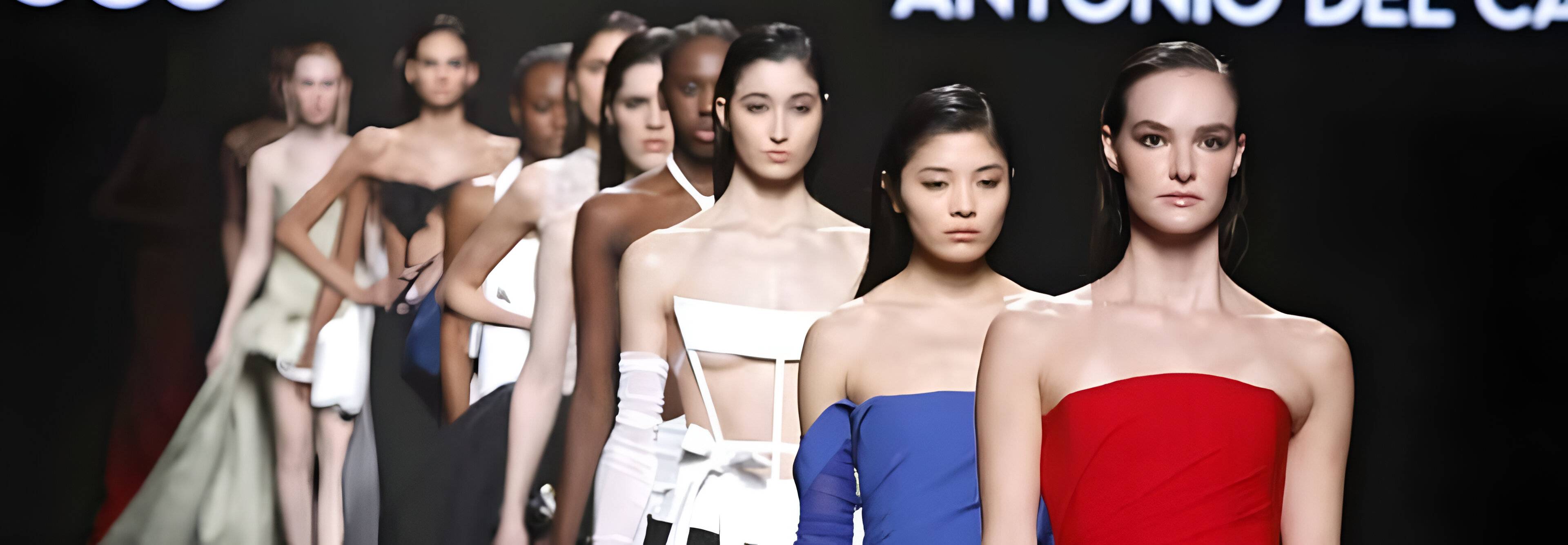 Modelo desfilando en una pasarela con vestidos de varios colores.