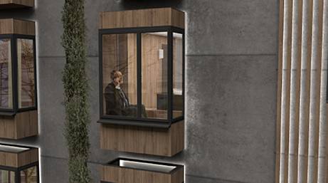 Un hombre está sentado dentro de una ventana estilizada de un edificio moderno.