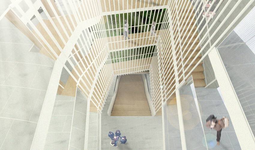 Vista aérea de una escalera moderna con barandillas blancas y un área verde en el fondo.
