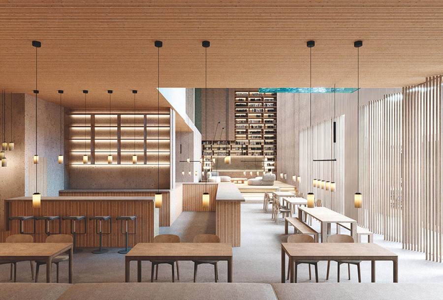 Interior moderno de un restaurante con mesas de madera y una iluminación suave.