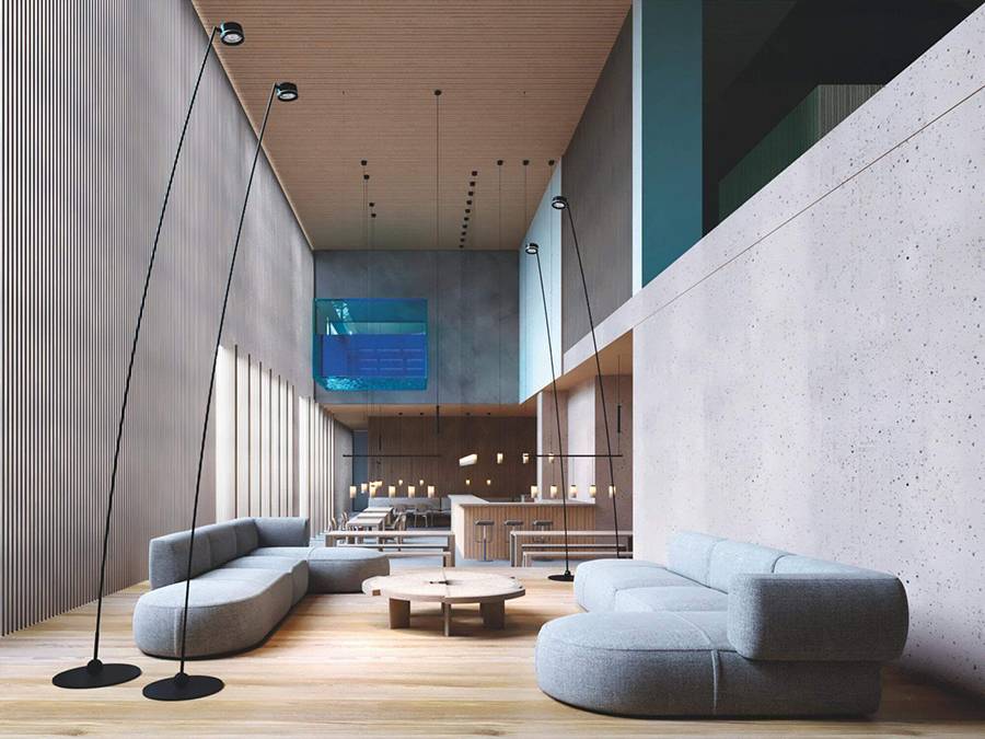 Una amplia sala con muebles modernos, iluminación contemporánea y paredes de concreto.