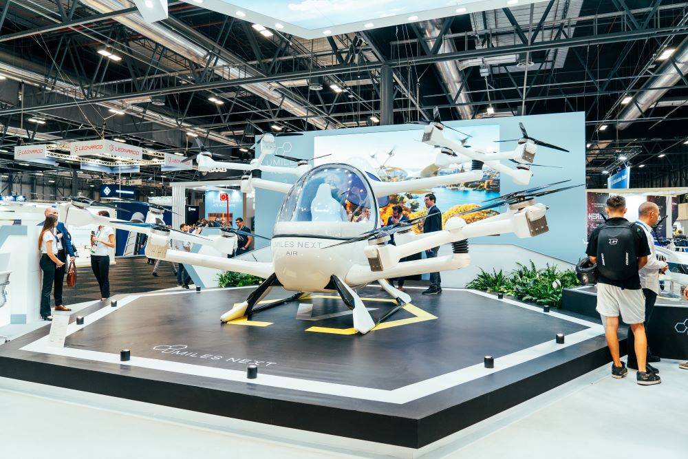 Un vehículo aéreo eléctrico futurista exhibido en un salón del automóvil.