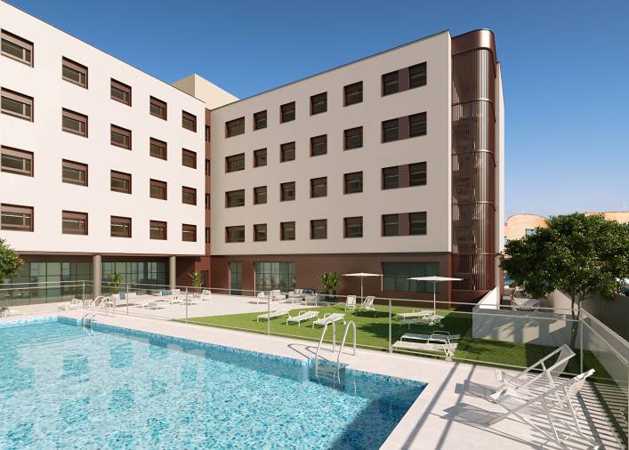 Una imagen de un hotel moderno con una piscina y áreas ajardinadas.